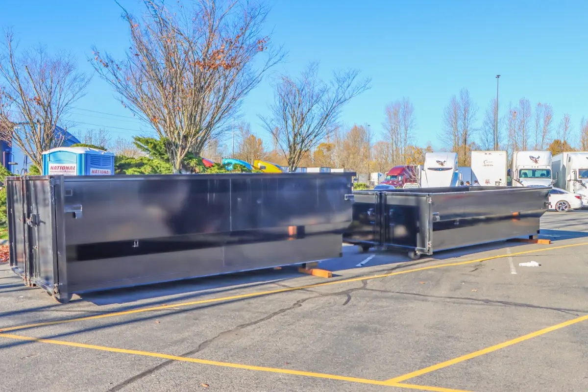 Professional dumpster rental service with roll-off container on residential driveway in Galliano